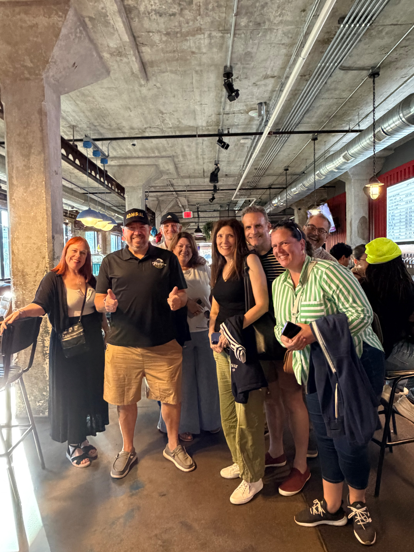 Admiral Jim giving two thumbs up with a group of guests